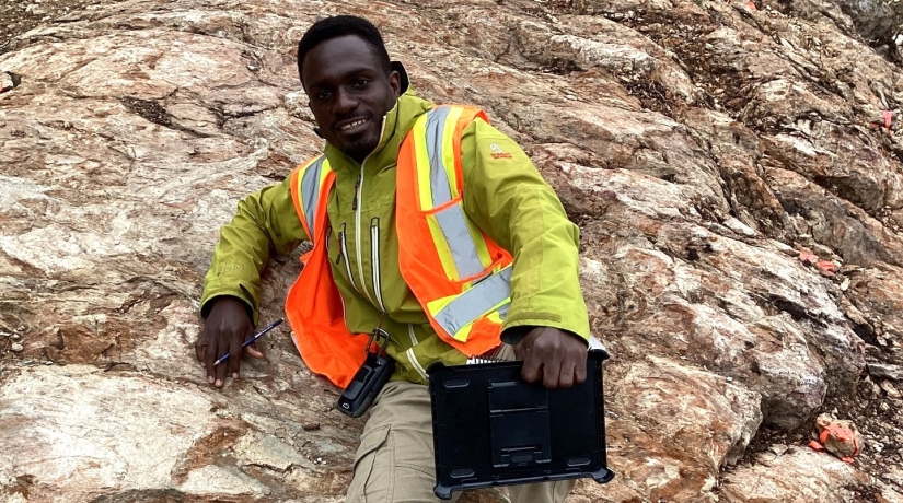 MSc student Samuel Tetteh takes a break on a rock outcrop he is studying